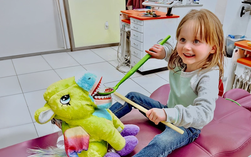 Little Girl Practicing Brushing On A Plushie Alt